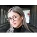 Woman wearing Rivington eyeglasses in oak barrel